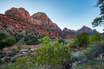 morning sunlight illuminating the canyons in Zion national park in Utah under a blue ,clear sky.