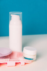 Cosmetic products and silicone facial cleansing brushe. Accessories for beauty treatments, facial cleansing brush. Front view