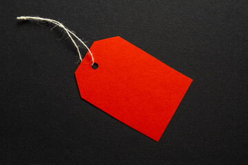 Red sale tag on dark background. Sale concept. Text space
