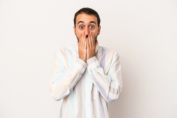 Young caucasian man isolated on white background shocked, covering mouth with hands, anxious to discover something new.