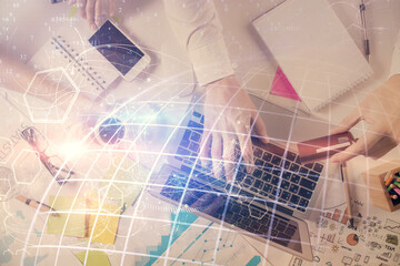 Multi exposure of man's hands typing over computer keyboard and world map hologram drawing. Top view. Technology concept.