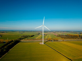 Aerial drone view of the wind turbine at the flat landscape in the Netherlands.