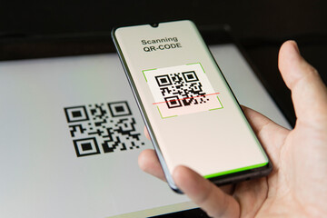 Scanning QR code with mobile smart phone. all graphics on the screen are made up. checking the qr...