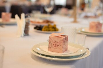 wedding table decor, pink box on a white plate