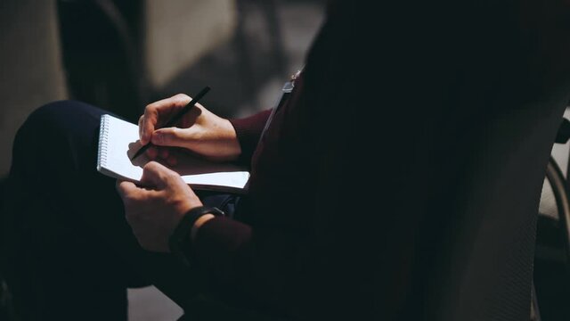 Close-up of a man's hand with a pen in his hand