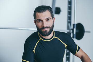 Portrait of a beautiful sweaty man after a training gym session. Young sporty boy at the end of the...