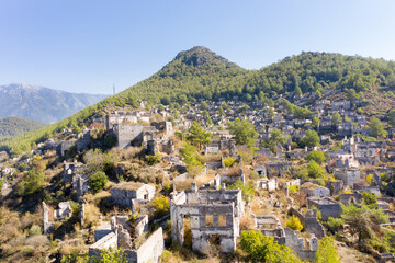 Fototapeta na wymiar Kayaköy Abandoned ghost town, stone houses and ruins. The site of the 18th century Ancient Greek city of Karmilissos. Aerial view, Fethiye - TURKEY