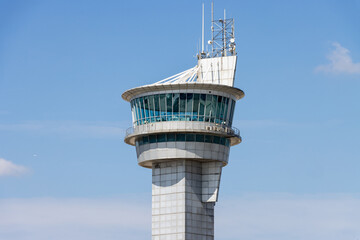 Fototapeta na wymiar Airport air traffic control tower. Flights management center. Isolated blue sky background