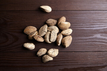 Brazil nuts or Bertholletia excelsa seeds on wooden table