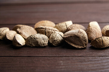 Brazil nuts or Bertholletia excelsa seeds on wooden table
