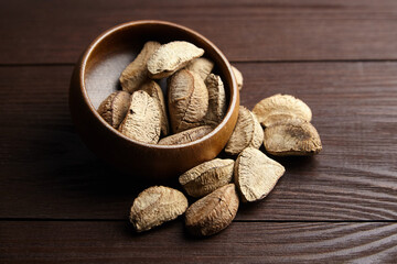 Brazil nuts or Bertholletia excelsa seeds in bowl on wooden table
