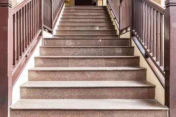 Fototapeta na wymiar Building exterior stairs with antique red brown granite tiles