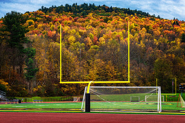Autumn leaves and Goal Post in the small town of Windsor in Broome County NY.  Local school's pathetic field the nice fall afternoon. - obrazy, fototapety, plakaty