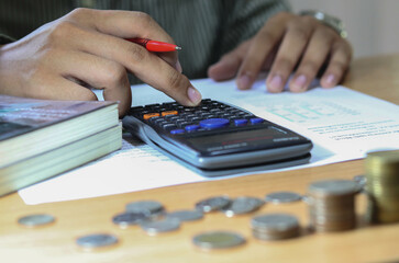 businessman working on desk office with using a calculator to calculate the numbers, finance...