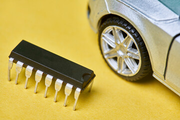 CPU chip and semiconductors with car toy. Global car chip shortage. Micro-chip shortage creates...