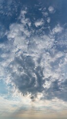 Fantastic clouds at sunrise, vertical panorama