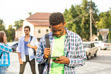 Fototapeta premium The young african student uses navigation on a smartphone