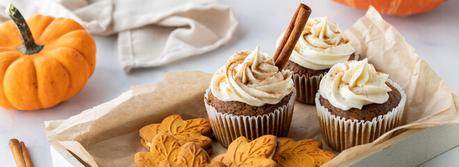 Narrow view of a tray of pumpkin spice cupcakes and cookies ready for snacking.