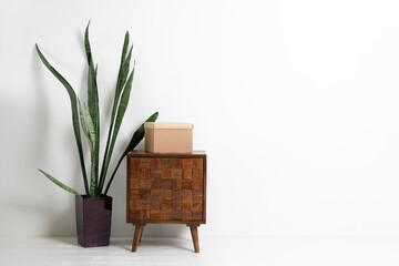 Paper box on wooden curbstone. White living room design. View of modern scandinavian style interior