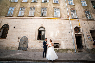 Happy newlywed bride and groom in the old city