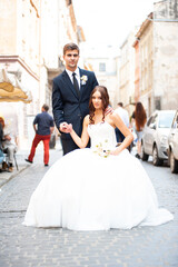 Happy newlywed bride and groom in the old city