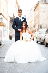 Happy newlywed bride and groom in the old city