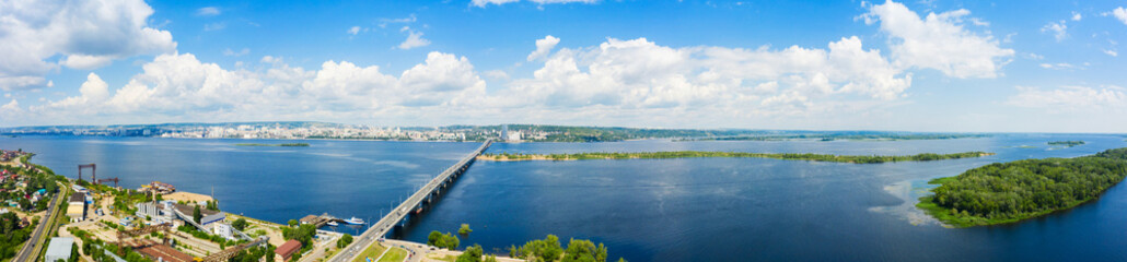 a panoramic view of the banks of the Volga River near Saratov, an automobile bridge across the river in the city limits