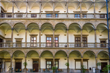 Courtyard of a renaissance chateau, complex of a historic palace, arcades and renaissance arches,