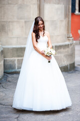 Obraz premium Fashion bride white wedding dress in the old city