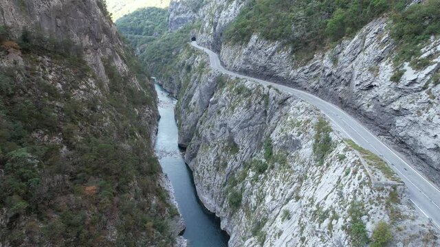 Aerial view of the Tara river canyon, big mountains and road with cars in north Montenegro, Europe, travel and nature concept