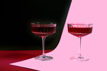 two glasses of red wine on a bright background, a festive and fun concept. advertising of new vintage red wine, American-style parties. poster. copy space. romantic evening
