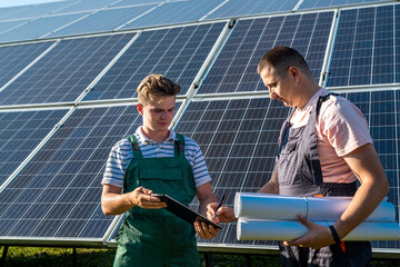 foreman and engineer work on the restoration and inspection of solar panels