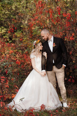 walk of the bride and groom through the autumn forest