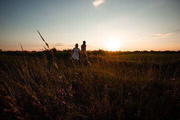 Lovely couple walking in the summer field