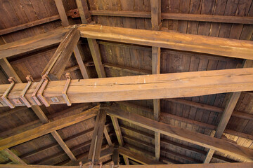 Old wooden truss structure called Palladian truss with beams and wooden roof