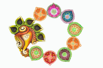 Circular Floral Decoration Rangoli Of Diya, Deep Or Dia With Bhagwan Ganesha Head. White Background With Copy Space At Centre. Theme For Diwali, Navratri Pooja, Ganesh Chaturthi Puja, Shubh Deepawali