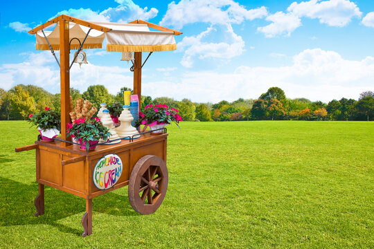 Pretty Wooden Portable Traditional Italian Picturesque Ice Cream Cart With Umbrella In A Public Park