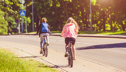 Fototapeta premium Cyclists ride on the bike path in the city Park 