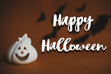 Happy Halloween text sign on jack o lantern pumpkin on dark orange background flying black bats....