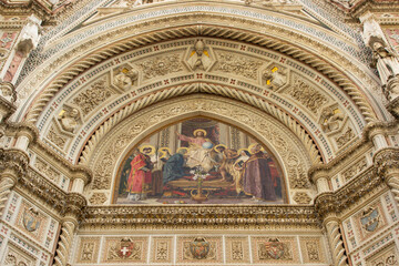 Fototapeta na wymiar Presco painting above the entrace of the Cathedral of Florence detailed frontal close up, Duomo di Firenze, Italy