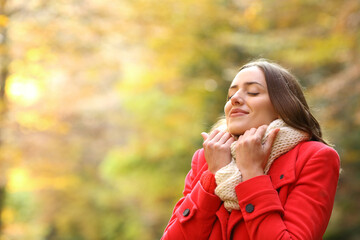 Happy woman warmly clothed in autumn