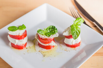 Caprese salad with mozarella cheese,tomatoes and basil.Top view