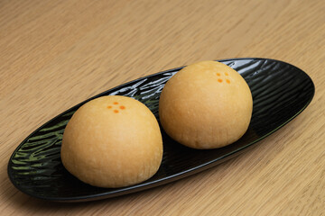 Closeup of Daifuku, Japanese traditional sweets in in black plate.
