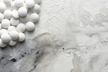 A handful of pills scattered on the table. A vial of medicines. Marble surface. Medicines. Stop COVID.