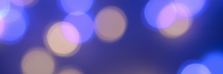 Banner made with the blurred lights of the garlands are blue and yellow. Light Blue bokeh background. Festive background. New Year's background.