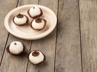 Typical gourmet brazilian brigadeiros, various flavors over wooden table with copy space