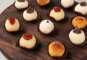 Typical gourmet brazilian brigadeiros, various flavors over wooden table