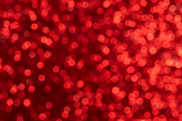 Red sparkling glitter bokeh background, christmas abstract defocused texture. Holiday lights