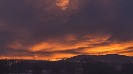 Obraz premium sunset - red sky above hilly landscape