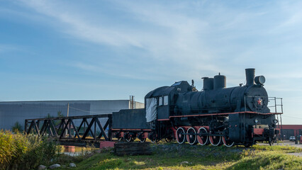 Retro Soviet steam locomotive. Veteran railways. Vintage black steam locomotive train rush railway.